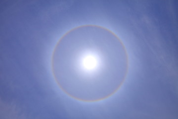 Stunning ring of sun halo with deep blue sky on sunny day