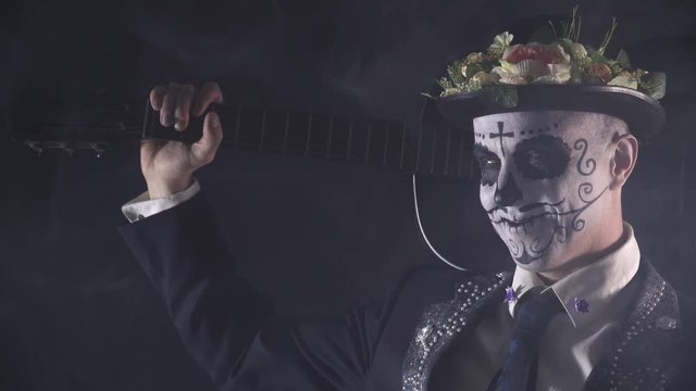Close up of mariachi with the face paint from Santa Muerte and a guitar, 4k