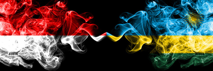 Indonesia vs Rwanda, Rwandan smoky mystic flags placed side by side. Thick colored silky smoke flags of Indonesia and Rwanda, Rwandan