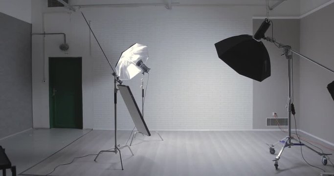 Empty photo stuid with c-stand, bouncing desk and octabox / steady cam moving shot