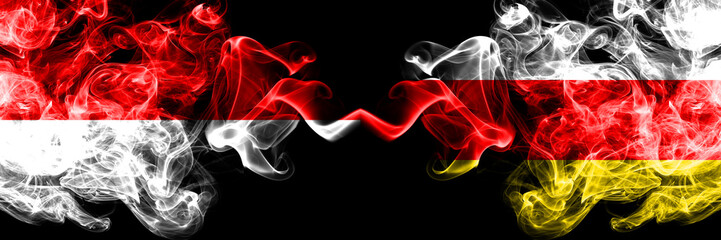 Indonesia vs South Ossetia smoky mystic flags placed side by side. Thick colored silky smoke flags of Indonesia and South Ossetia