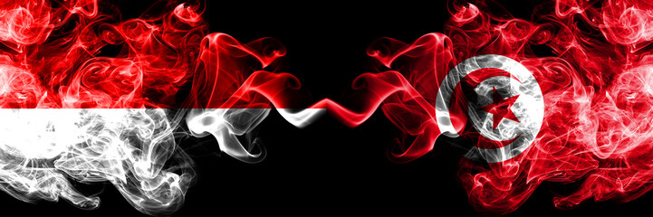 Indonesia vs Tunisia, Tunisian smoky mystic flags placed side by side. Thick colored silky smoke flags of Indonesia and Tunisia, Tunisian