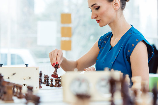 Woman playing chess in tournament