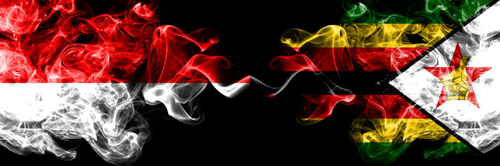 Indonesia vs Zimbabwe, Zimbabwean smoky mystic flags placed side by side. Thick colored silky smoke flags of Indonesia and Zimbabwe, Zimbabwean