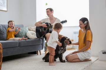 girl child with Down syndrome with family and dog