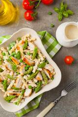 Italian pasta fusilli. Salad with chicken and asparagus in Béchamel sauce.