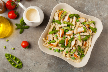Italian pasta fusilli. Salad with chicken and asparagus in Béchamel sauce.