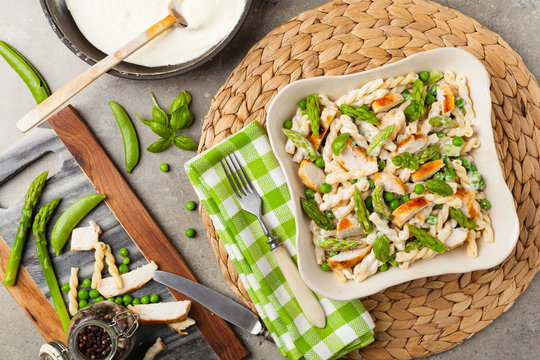 Italian pasta fusilli. Salad with chicken and asparagus in Béchamel sauce.