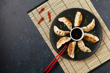 Original Japanese dumplings Gyoza with chicken and vegetables.Top view. Flat lay. Dark blue backgrund.