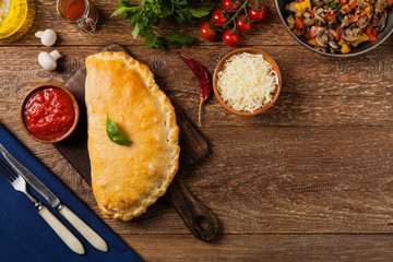 Italian calzone with mushrooms and ham. Top view.