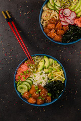 Hawaiian salmon poke bowl with seaweed, avocado, sesame seeds.