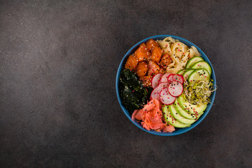 Hawaiian salmon poke bowl with seaweed, avocado, sesame seeds.