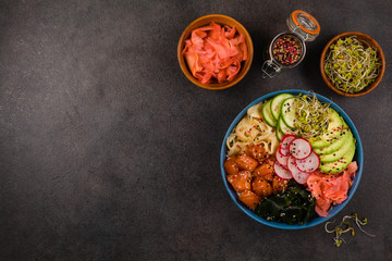 Hawaiian salmon poke bowl with seaweed, avocado, sesame seeds.