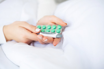 Obraz na płótnie Canvas Medical pills. Woman extracting a pill from the blister