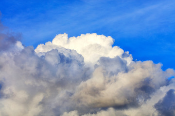 Naklejka na ściany i meble White-gray big cloud closeup in the blue sky.