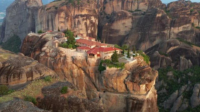 Aerial view of a slide from a drone on a panorama of a mountain range. Kalambaka city, Greece. The tops rocks of Meteora. Orthodox monastery in the mountains of Meteora. Monastery of the Holy Trinity