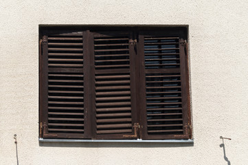 Close up view of closed window with wooden shutters