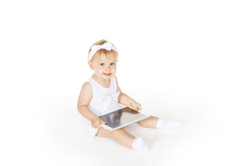 little girl all in white with a tablet