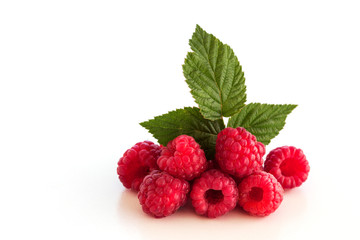 Still life. Ripe, red raspberry berries with green leaf on a white background. Close-up. Isolated.