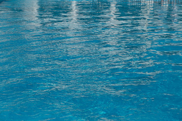 Blurred water texture in summer pool close up.