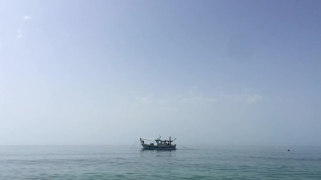 Shrimp boat in the Mediterranean, in front of the coast of Malaga. Picking the typical "concha fina" Malaga&rsquo;s clam (Cytherea chione)