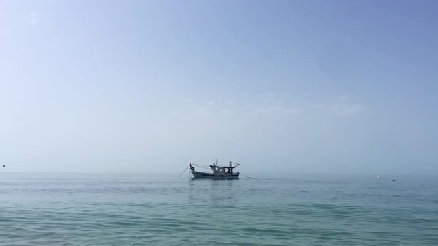 Shrimp boat in the Mediterranean, in front of the coast of Malaga. Picking the typical "concha fina" Malaga&rsquo;s clam (Cytherea chione)