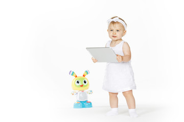 little girl all in white with tablet and toy