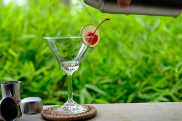 glass of red wine on wooden table in the garden