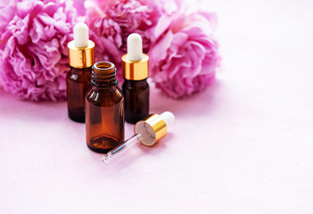 Aromatherapy essentials oils and pink peonies