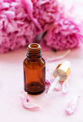 Aromatherapy essentials oils and pink peonies