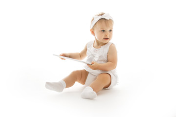 little girl all in white with a tablet