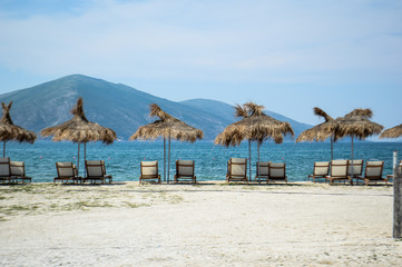 View of the beach with umbrellas and deck chairs in Albania