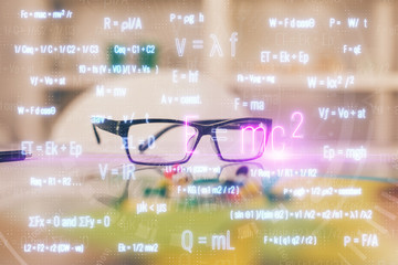 Formulas drawing with glasses on the table background. Concept of science. Double exposure.