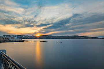 The panorama of harbour on St Paul's Bay with fishing boats and tourist ships, Bugibba, Malta
