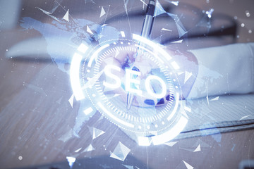 Double exposure of woman's hands making notes with SEO icon. Concept of Search engine optimization