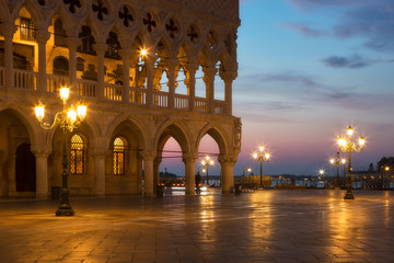 Famous Doge palace, column with winged lion and San Marco square at sunrise in Venice, Italy