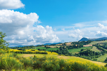 Countryside landscape, green hills and blue sky