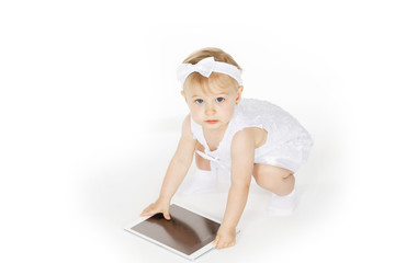 little girl all in white with a tablet