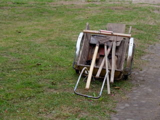 garden tools loaded in a wheelbarrow in the village