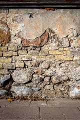 Old cracked plaster and brick wall