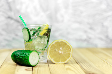 refreshing, vitamin lemonade, cucumber water with mint and lemon in a glass, copy spaсe
