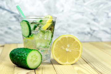 refreshing, vitamin lemonade, cucumber water with mint and lemon in a glass, copy spaсe