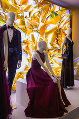 Female dummies in stylish and fashionable clothes in a show-window of shop. New collection. 