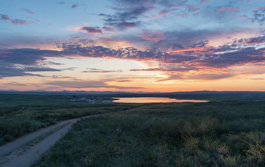 Landscape in Tuva. Dus-Hol lake and road in field