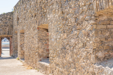 An ancient destroyed building with a door and windows