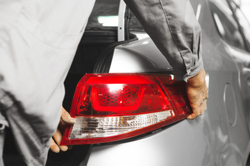 Installation a tail light on car, close-up.