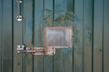 Photo of green iron door with window