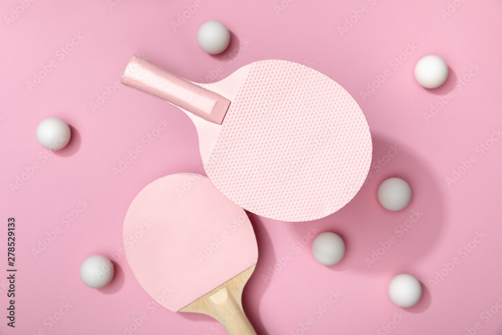 Wall mural top view of white table tennis balls and rackets on pink background