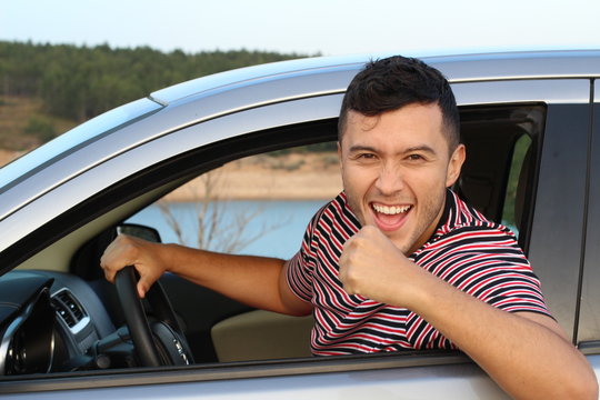 Victorious driver raising his arm 