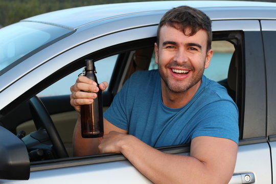 Irresponsible driver drinking a beer 
